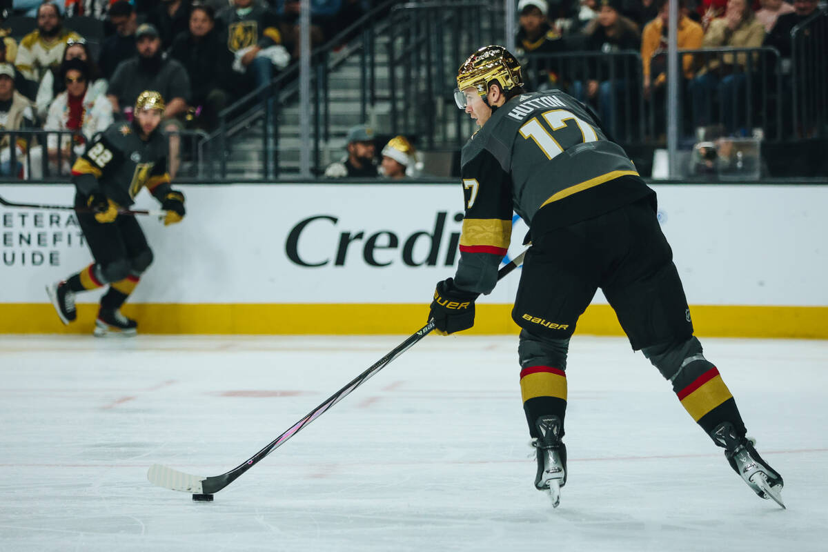 Golden Knights defenseman Ben Hutton (17) shuffles the puck during a power play during a game a ...