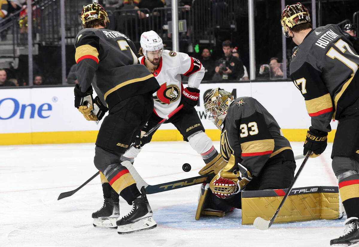 Vegas Golden Knights goaltender Adin Hill (33) blocks a shot by Ottawa Senators center Mark Kas ...