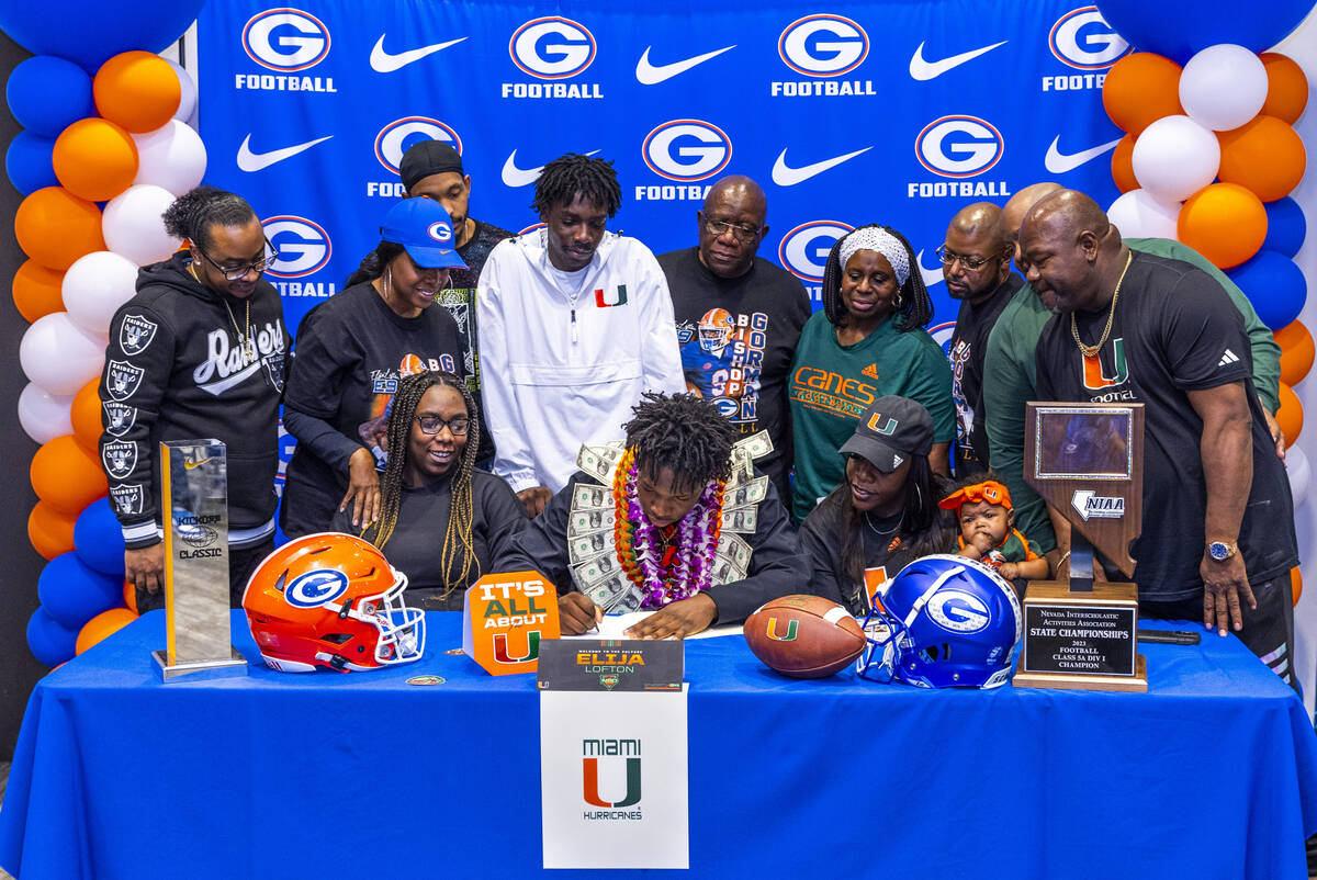 Bishop Gorman player Elija Lofton and family with a commitment letter to the University of Miam ...