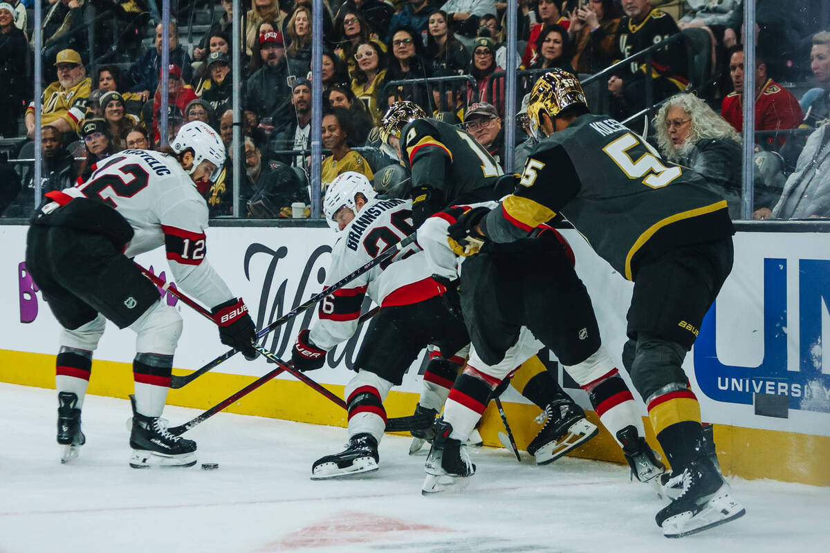 Ottawa Senators defenders fight for a puck as Golden Knights center Nicolas Roy (10) and Golden ...