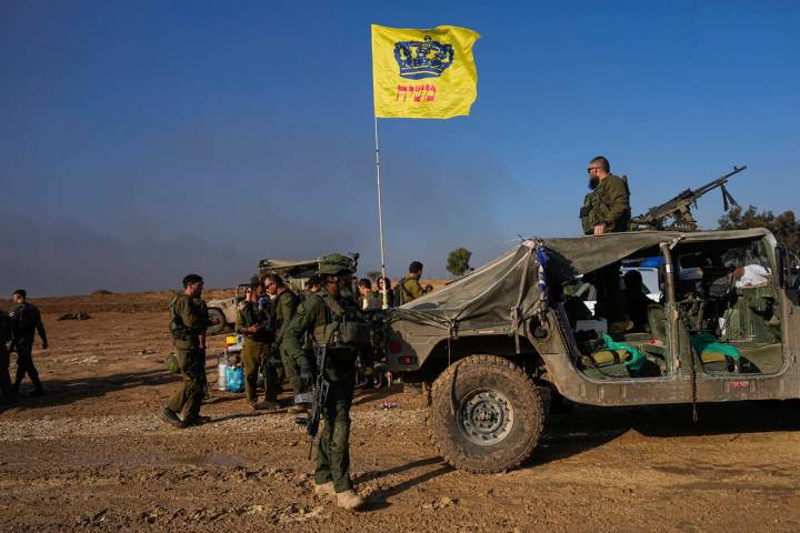 Israeli soldiers are seen at a staging area near the Israeli-Gaza border, in southern Israel, M ...