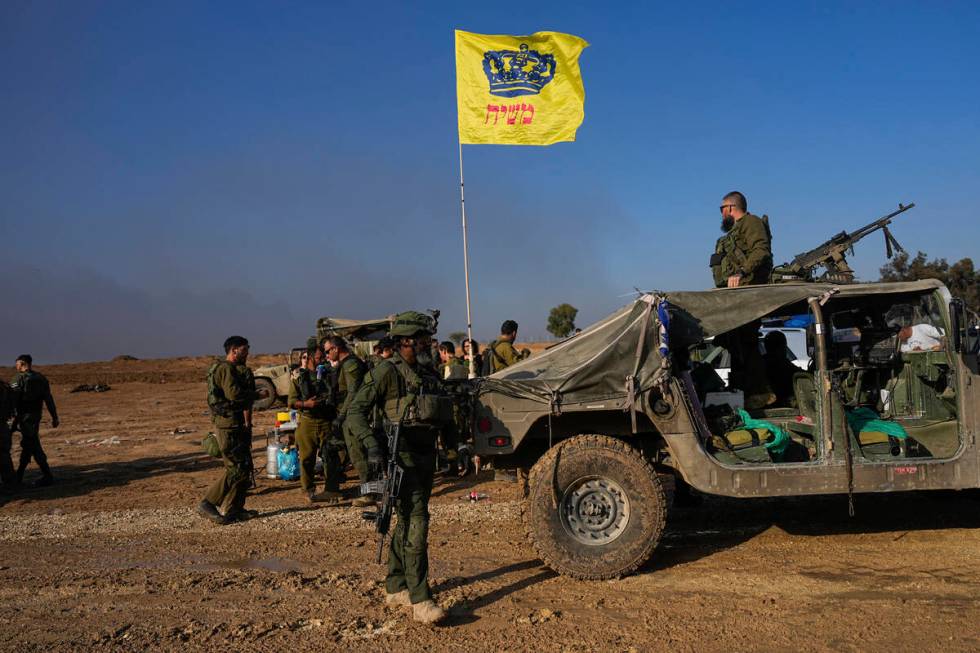 Israeli soldiers are seen at a staging area near the Israeli-Gaza border, in southern Israel, M ...