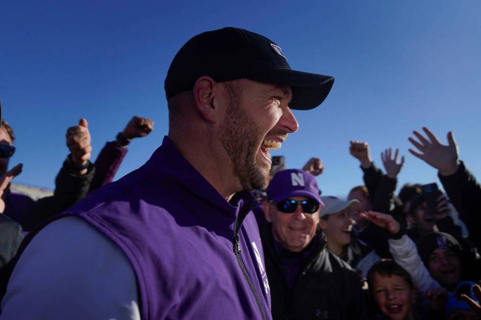 Northwestern head coach David Braun celebrates his team's 23-15 win over Purdue after an NCAA c ...