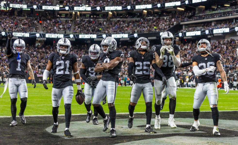 Raiders cornerback Amik Robertson (21) celebrates his interception with teammates against the N ...