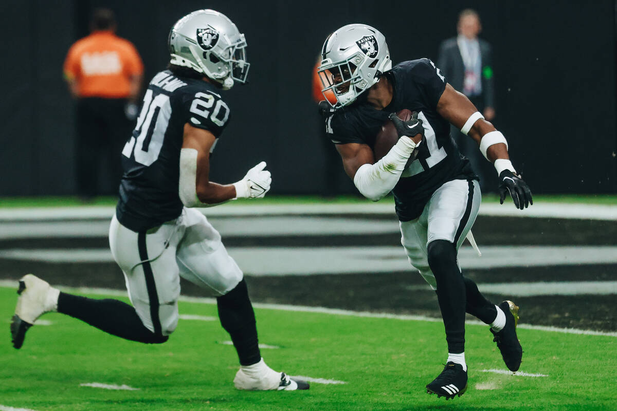 Raiders cornerback Amik Robertson (21) runs the ball after intercepting it during a game agains ...