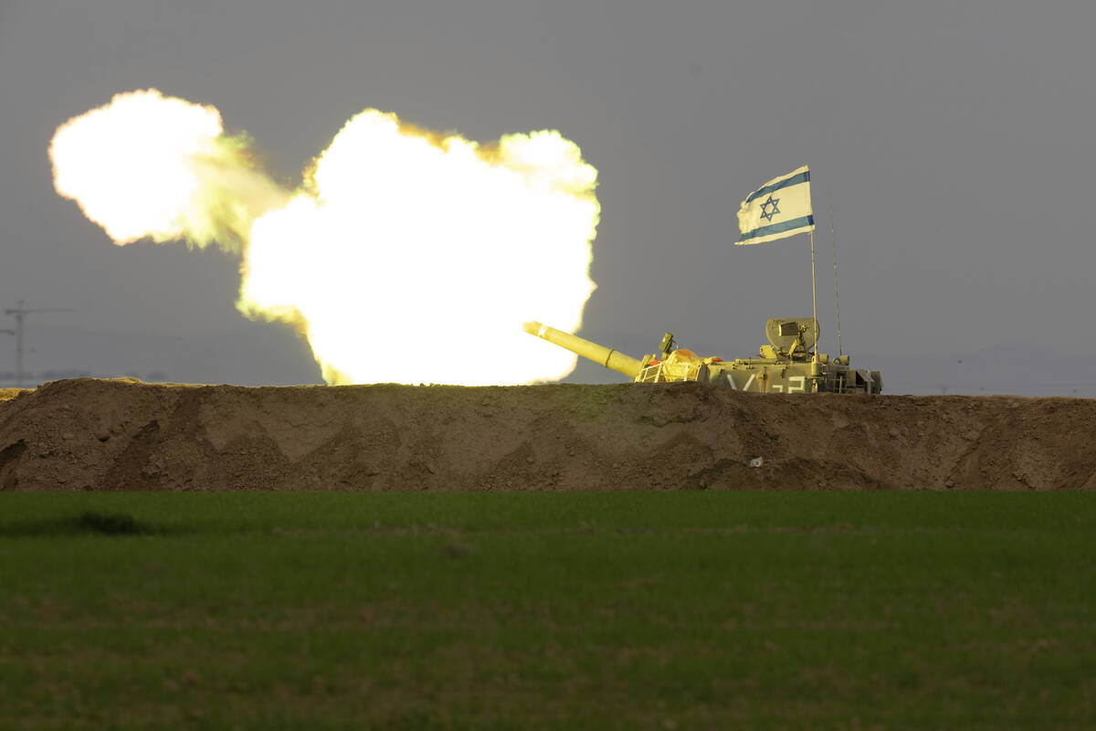 An Israeli mobile artillery unit fires a shell from southern Israel towards the Gaza Strip, in ...