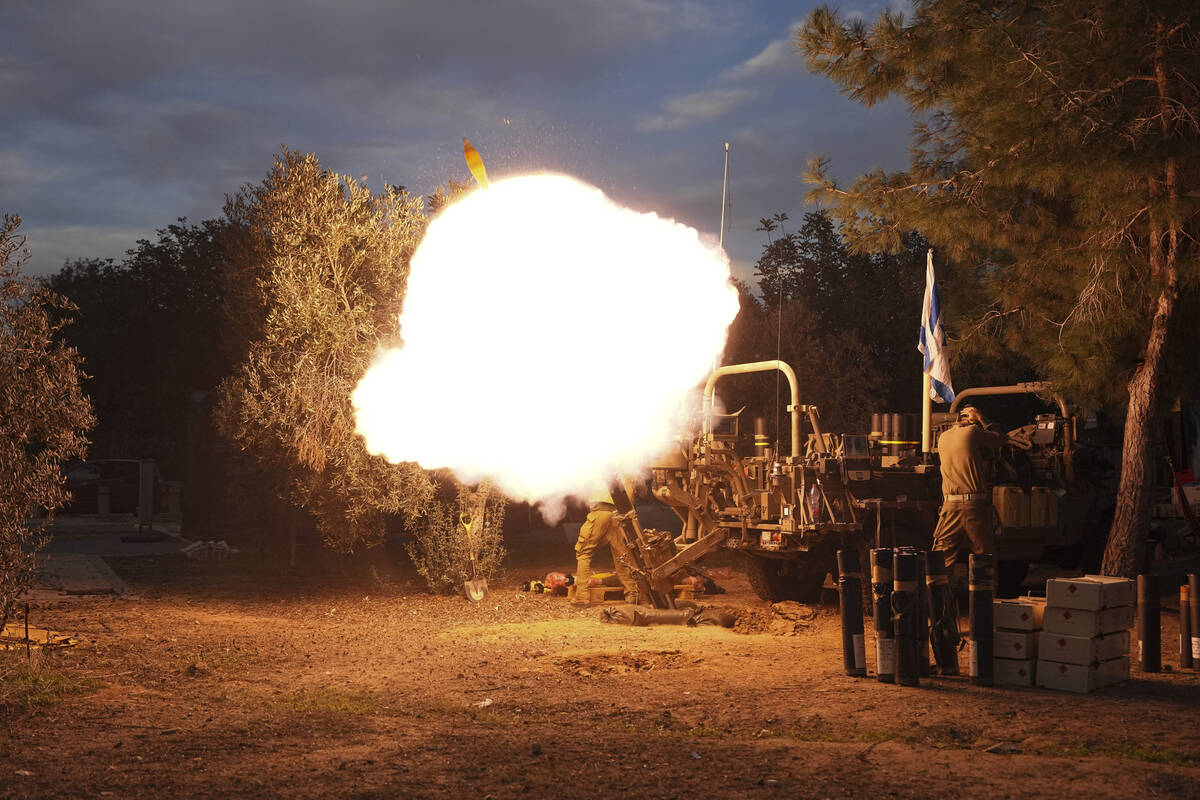 Israeli soldiers fire mortars from southern Israel towards the Gaza Strip, in a position near t ...