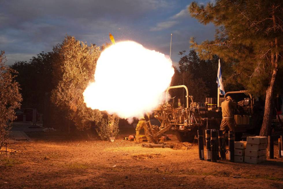 Israeli soldiers fire mortars from southern Israel towards the Gaza Strip, in a position near t ...