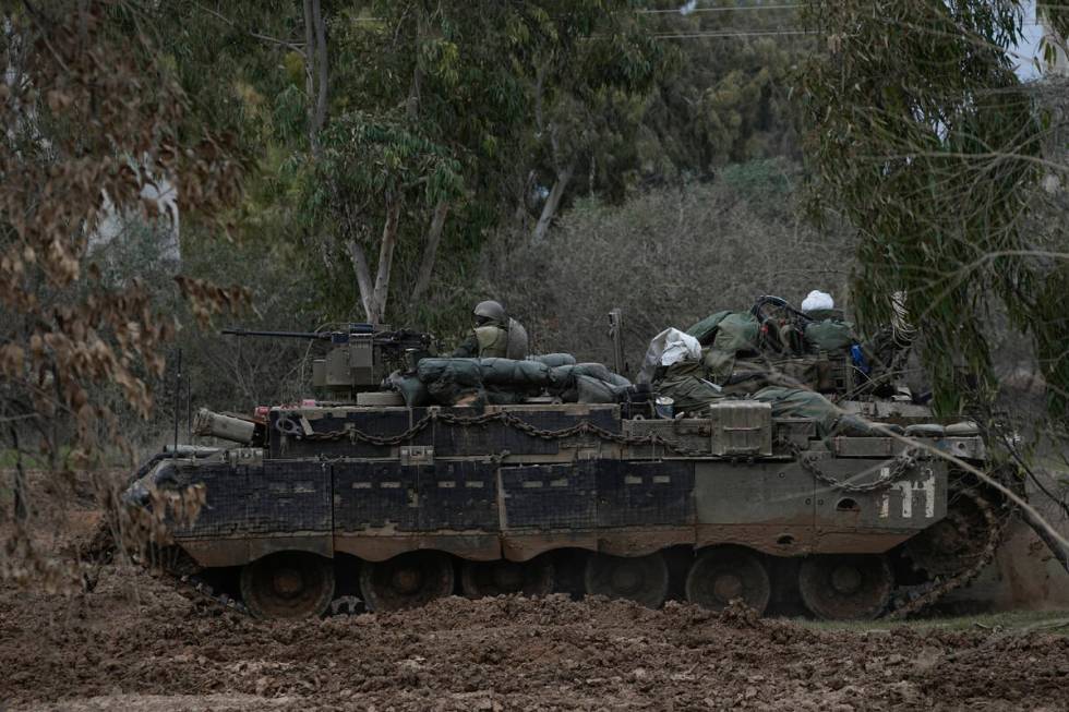 Israeli troops are seen near the Gaza Strip border, in southern Israel, Thursday, Dec. 21, 2023 ...