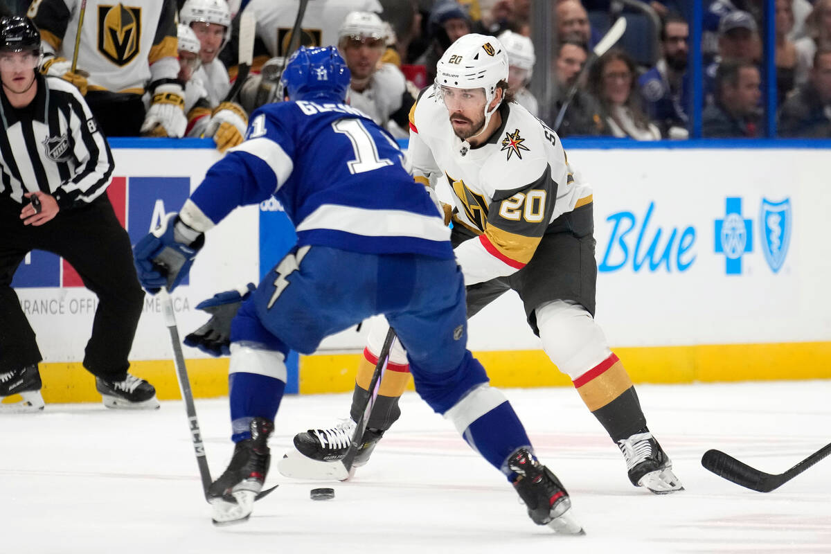 Vegas Golden Knights center Chandler Stephenson (20) moves the puck around Tampa Bay Lightning ...