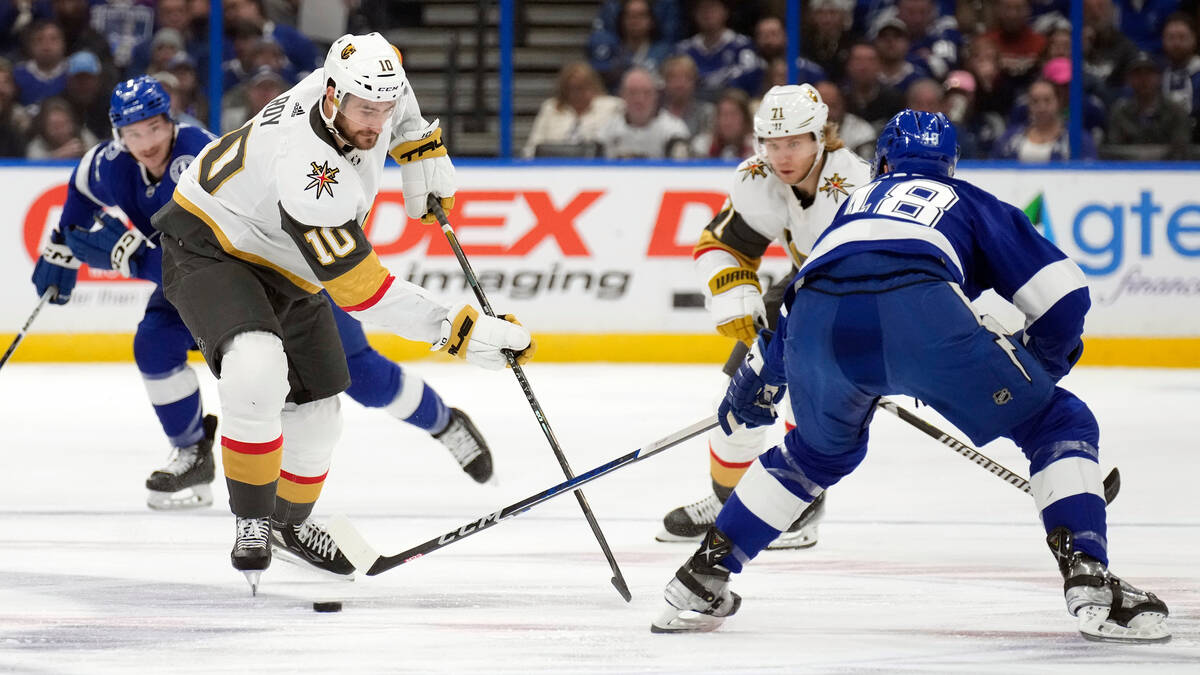 Vegas Golden Knights center Nicolas Roy (10) moves the puck in front of Tampa Bay Lightning def ...