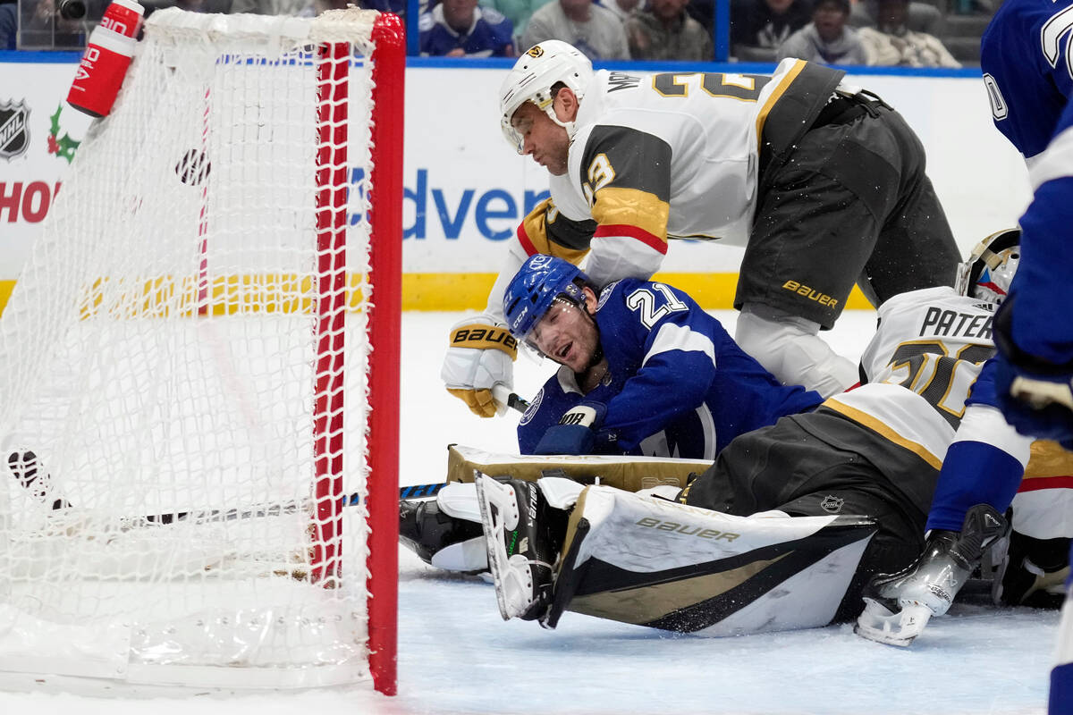 Tampa Bay Lightning center Brayden Point (21)- gets knocked down by Vegas Golden Knights defens ...