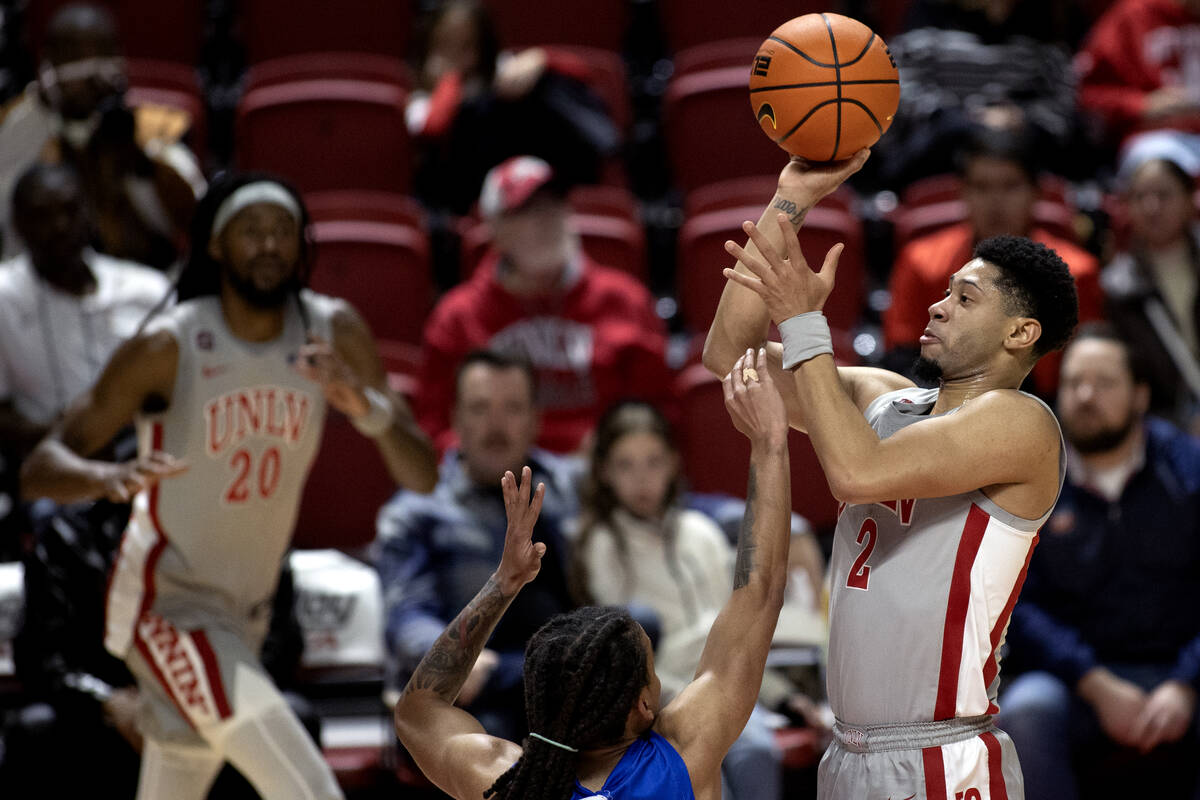 UNLV Rebels guard Justin Webster (2) shoots against Hofstra Pride guard Jaquan Carlos (5) durin ...