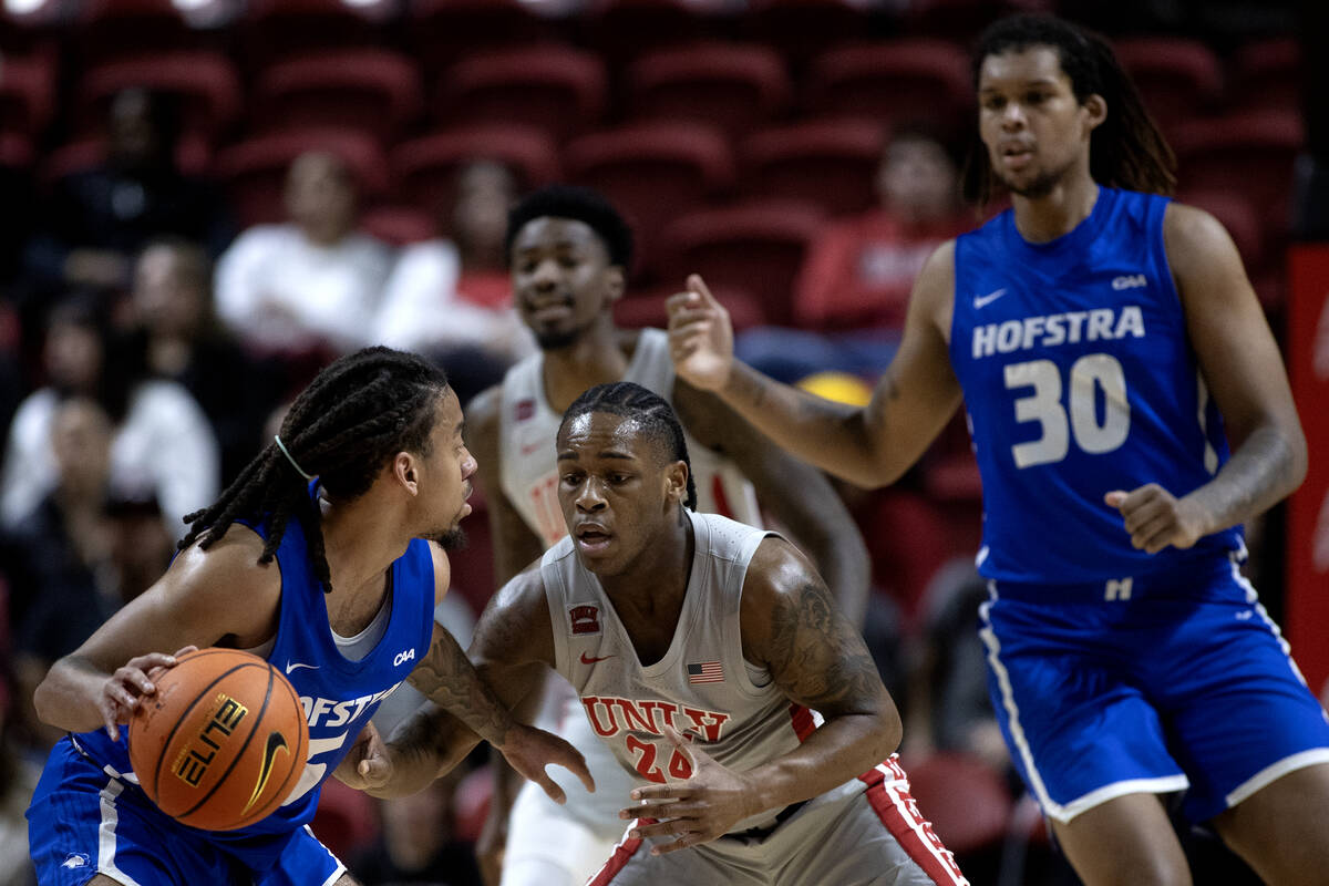 UNLV Rebels guard Jackie Johnson III (24) defends against Hofstra Pride guard Jaquan Carlos (5) ...