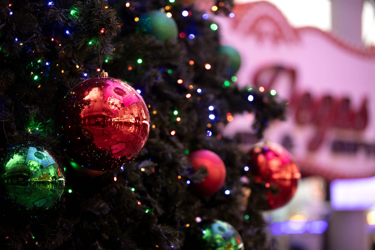 Fremont Street Experience is reflected in raindrop covered Christmas decorations on Friday, Dec ...