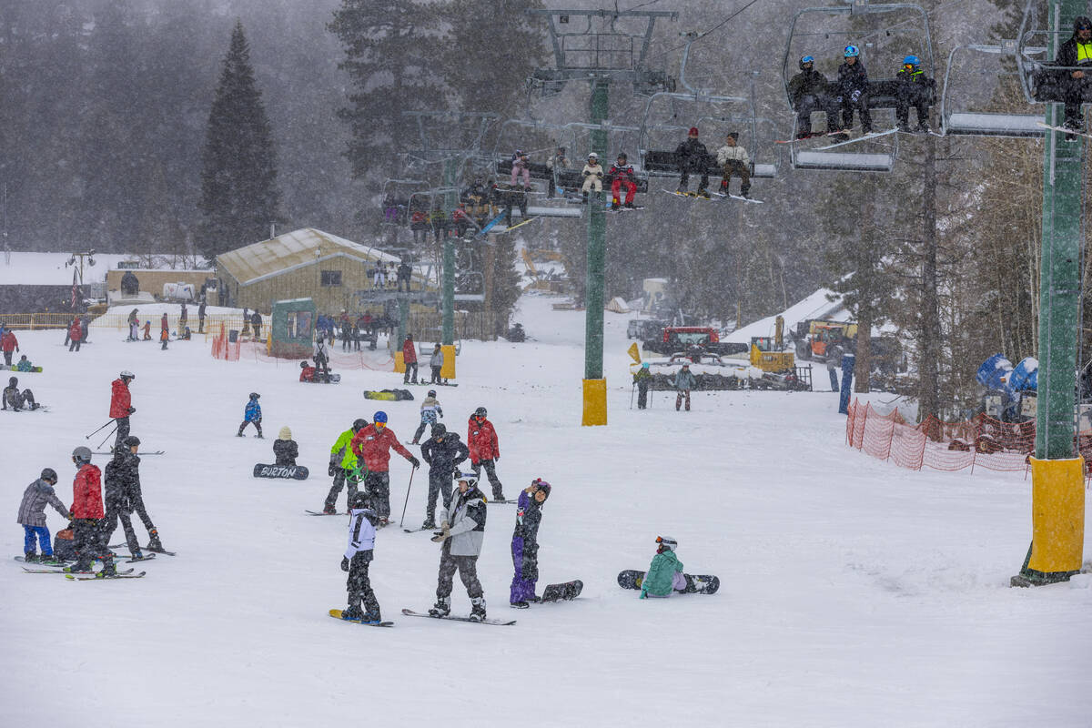 Skiers and snowboarders use the beginner lift and hill at the Lee Canyon Ski Resort as it conti ...