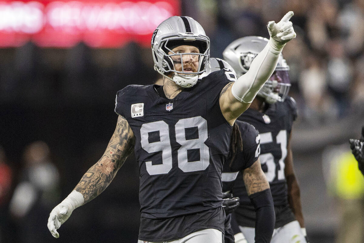 Raiders defensive end Maxx Crosby (98) points to signal Raiders ball after a turnover committed ...