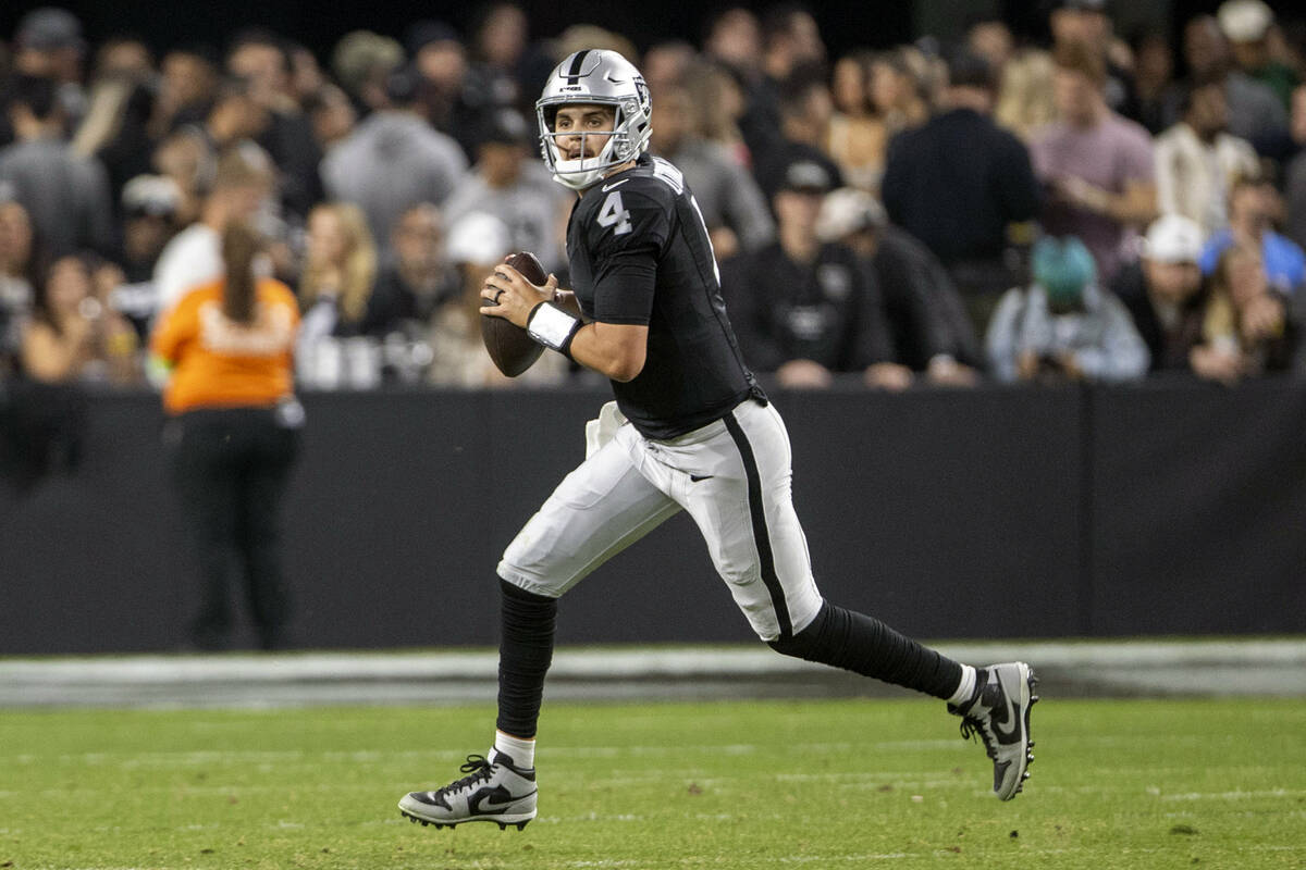 Raiders quarterback Aidan O'Connell (4) scrambles out of the pocket during the second half of a ...