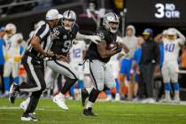 Raiders defensive tackle John Jenkins (95) runs with defensive end Maxx Crosby (98) after recov ...