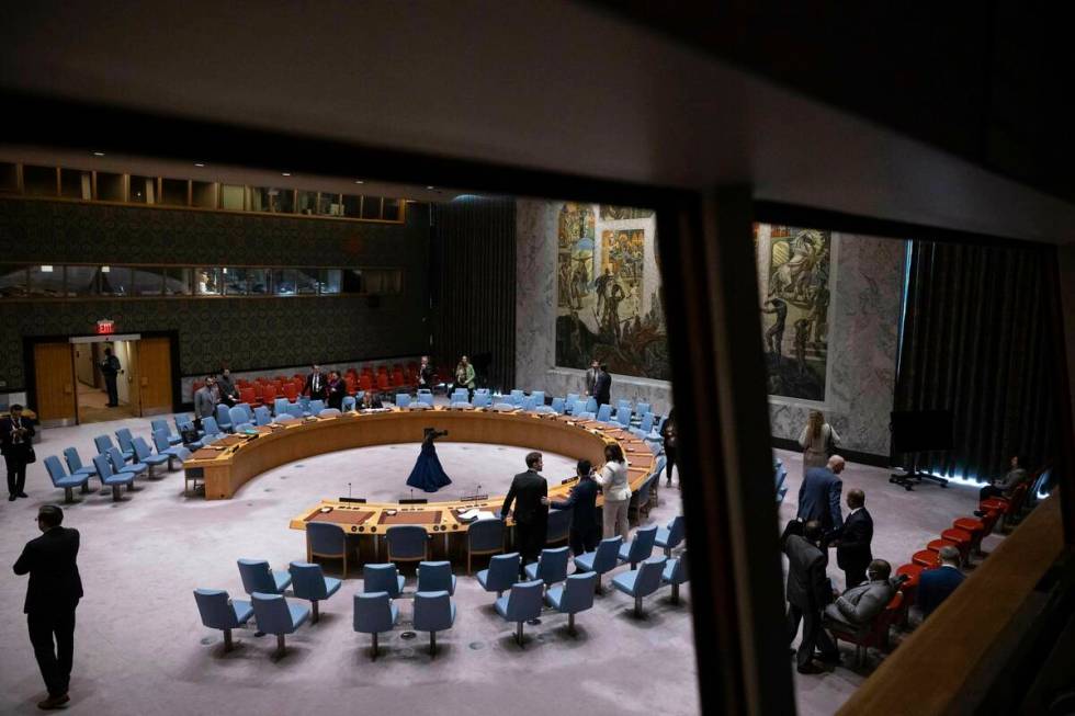 People gather during the Security Council meeting at United Nations headquarters, Friday, Dec. ...