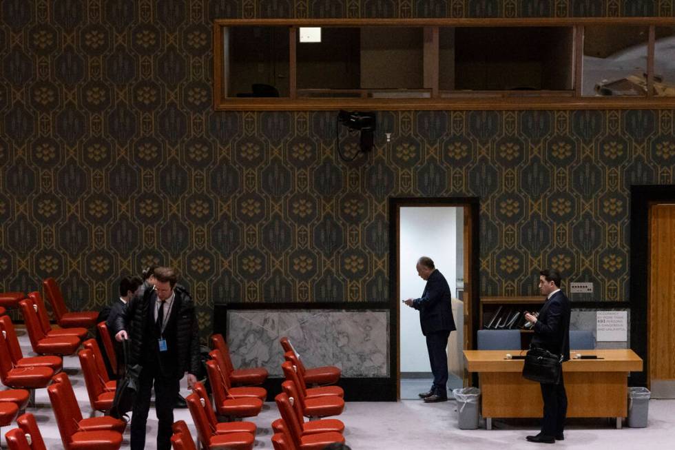 People stand in Security Council chamber at United Nations headquarters, Friday, Dec. 22, 2023. ...