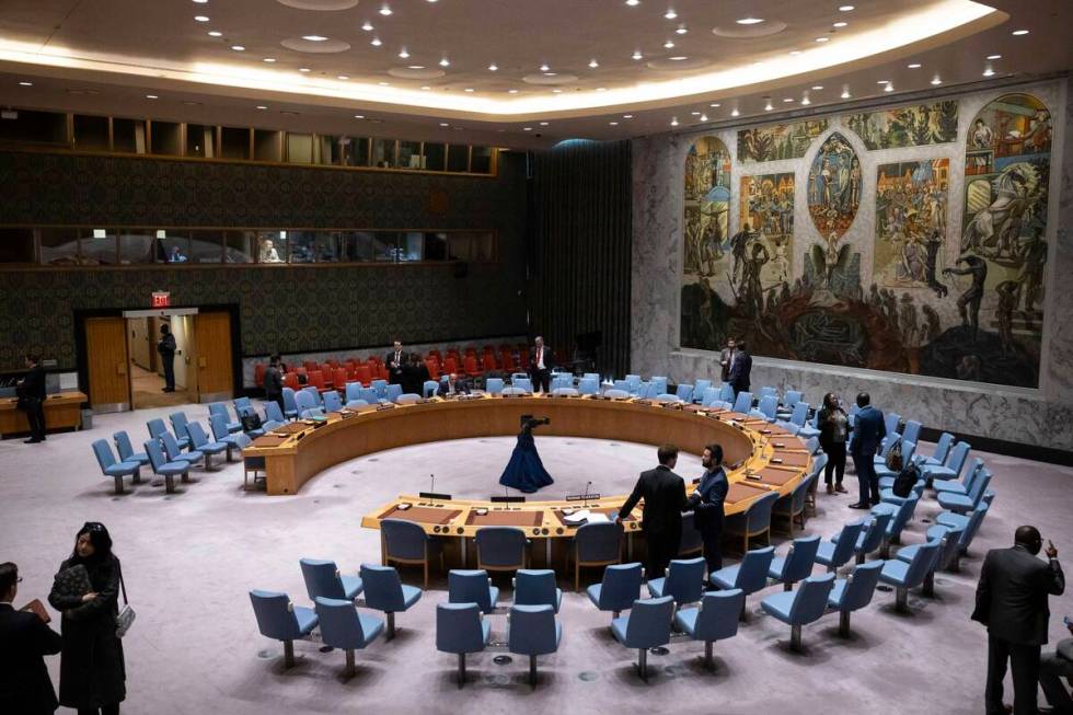 People gather during the Security Council meeting at United Nations headquarters, Friday, Dec. ...