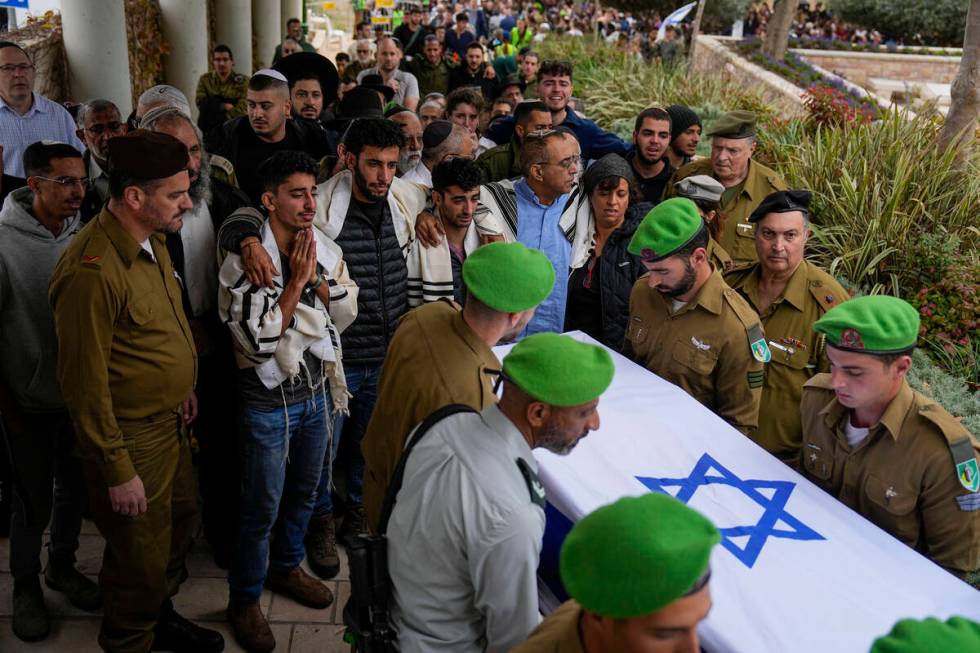 Israeli soldiers carry the flagged covered coffin of Sergeant Lavi Ghasi as family and friends ...