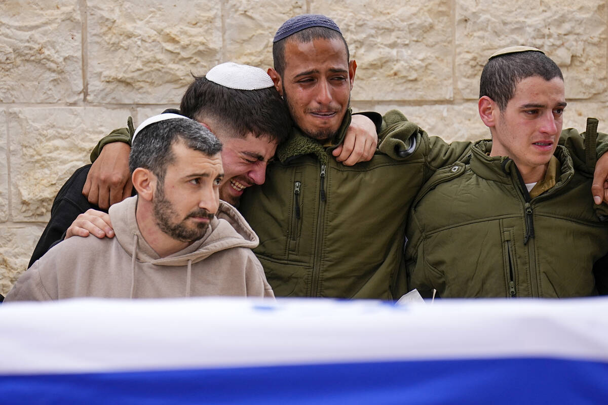 Friends of Sergeant Lavi Ghasi mourn during his funeral in Modiin, Israel,Thursday, Dec. 21, 20 ...