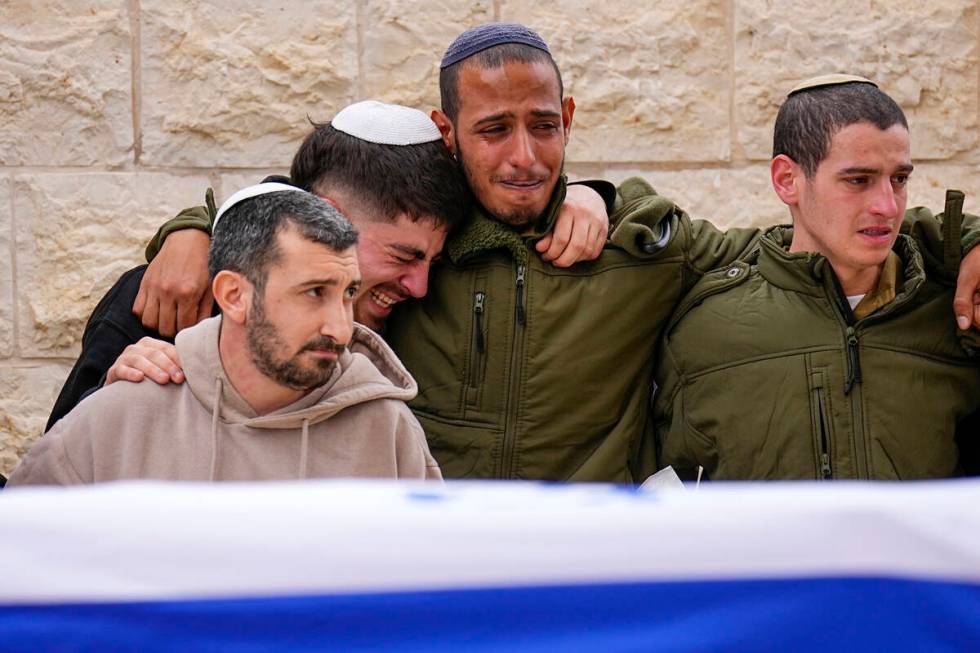 Friends of Sergeant Lavi Ghasi mourn during his funeral in Modiin, Israel,Thursday, Dec. 21, 20 ...