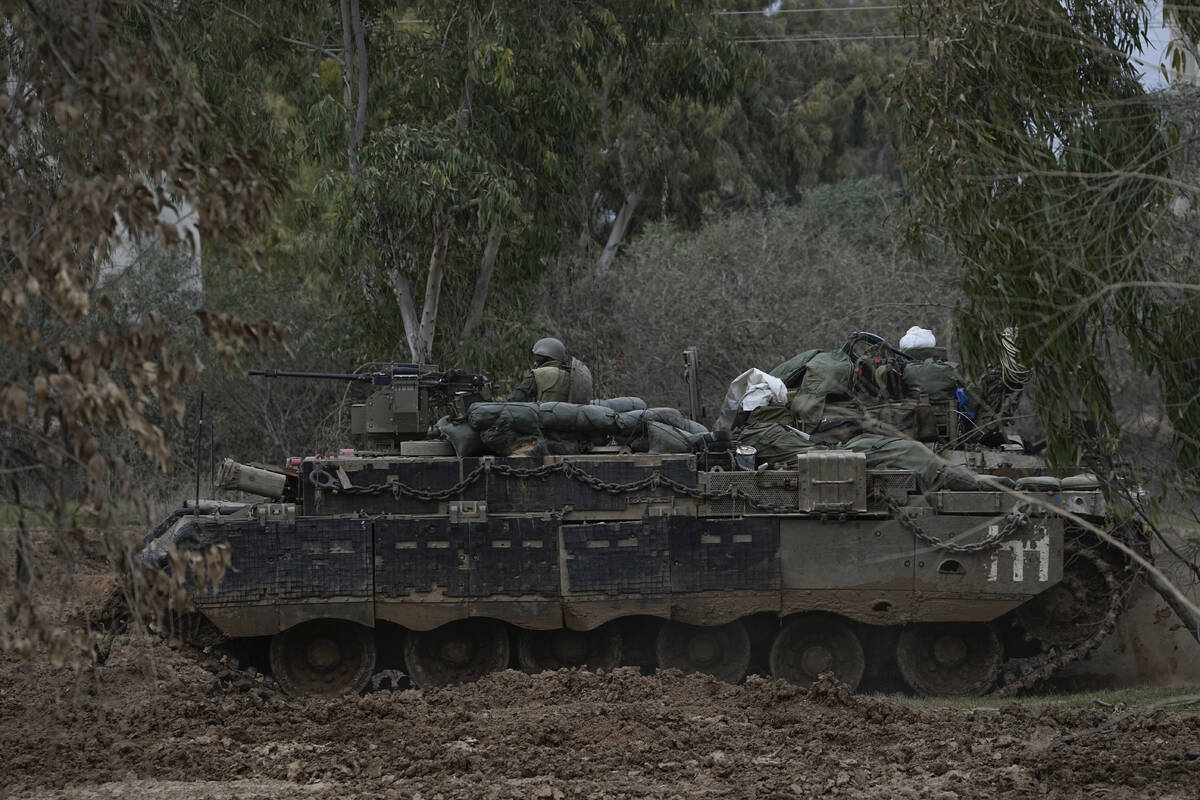 Israeli troops are seen near the Gaza Strip border, in southern Israel, Thursday, Dec. 21, 2023 ...