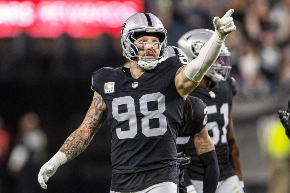 Raiders defensive end Maxx Crosby (98) points to signal Raiders ball after a turnover committed ...