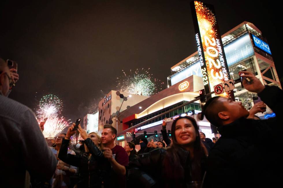 New Year’s revelers watch the fireworks on the Strip on Sunday, Jan. 1, 2023, in Las Vegas. ( ...