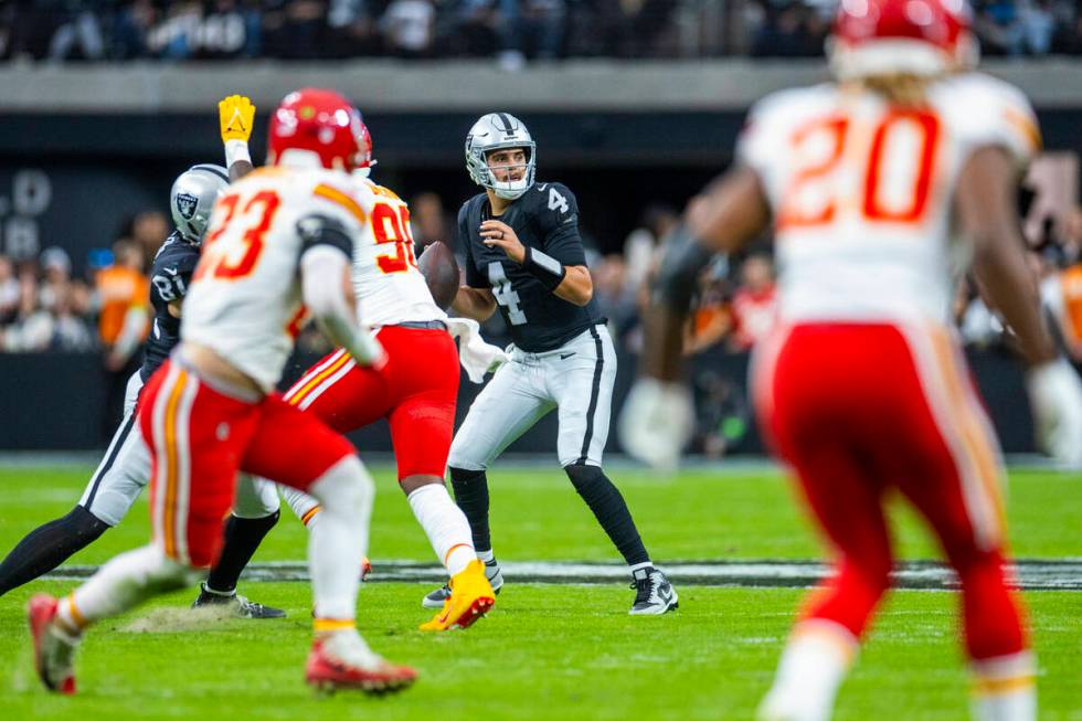 Raiders quarterback Aidan O'Connell (4) looks for a receiver against the Kansas City Chiefs dur ...