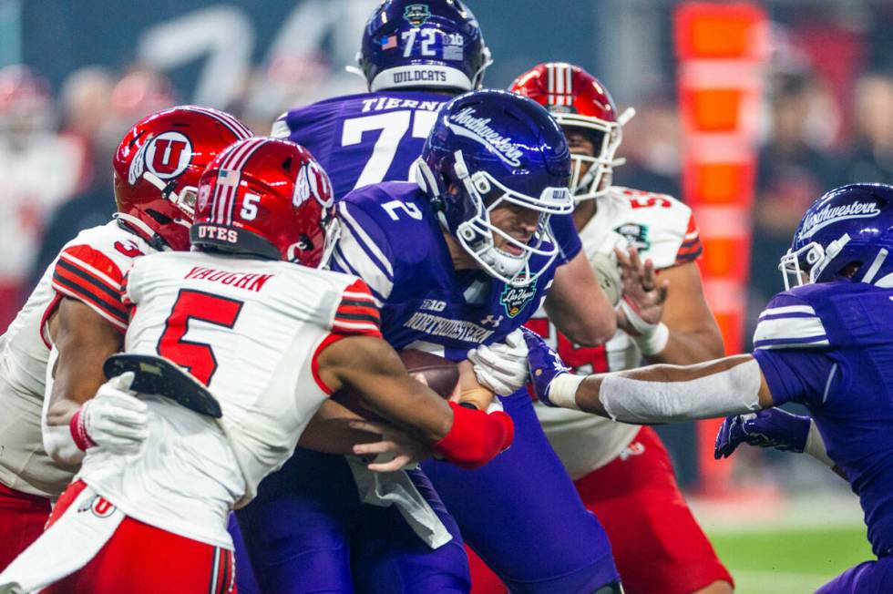 Northwestern Wildcats quarterback Ben Bryant (2) is sacked by Utah Utes cornerback Zemaiah Vaug ...