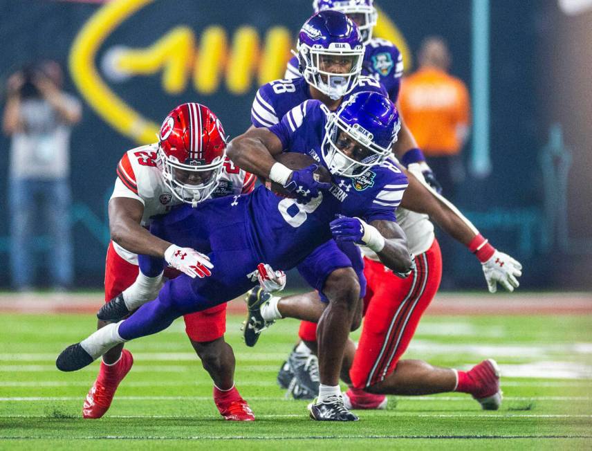 Northwestern Wildcats wide receiver A.J. Henning (8) runs back a punt as Utah Utes safety Austi ...