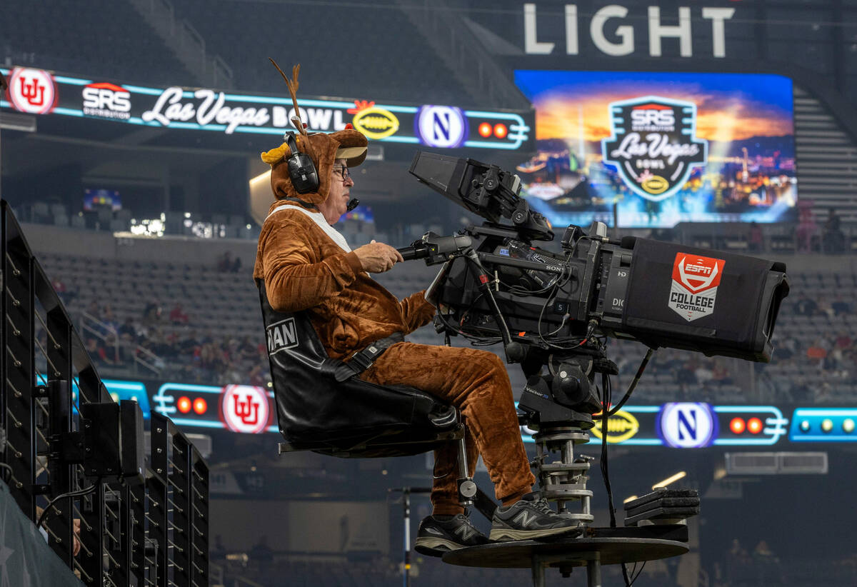An ESPN cameraman is dressed as a reindeer as the Utah Utes battle the Northwestern Wildcats du ...