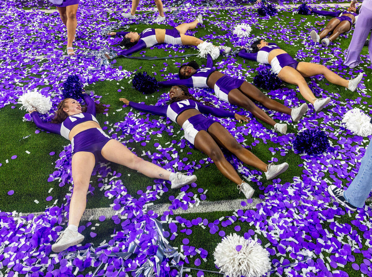 Northwestern Wildcats cheerleaders make confetti angels following their win defeating the Utah ...
