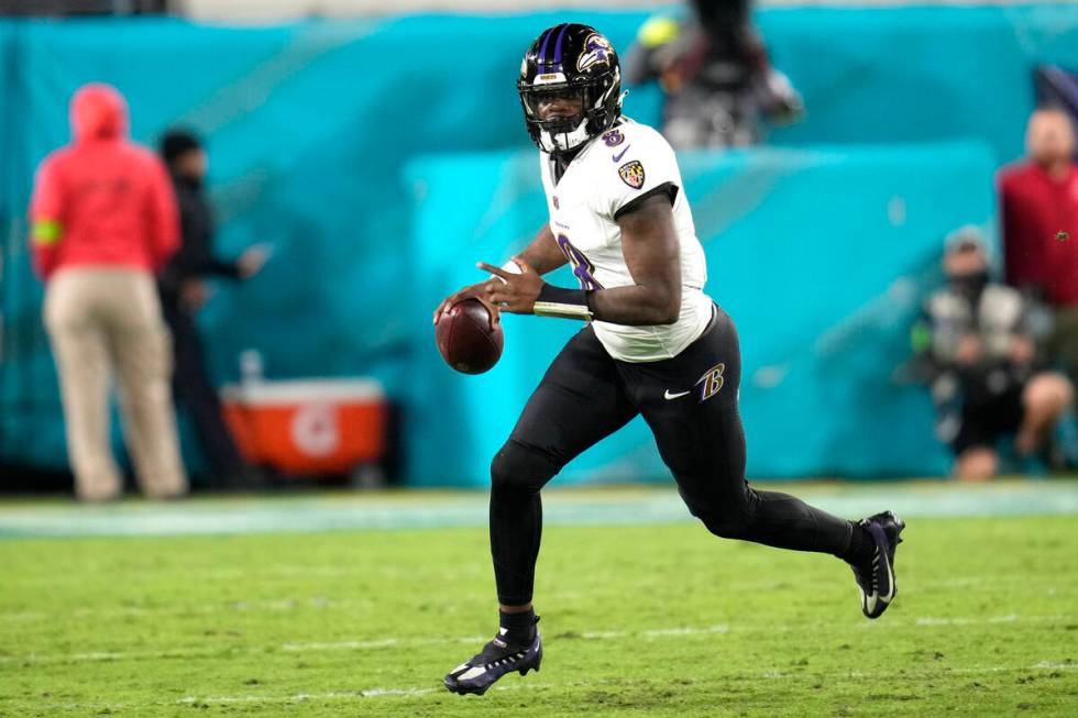 Baltimore Ravens quarterback Lamar Jackson (8) scrambles out of the pocket during the first hal ...