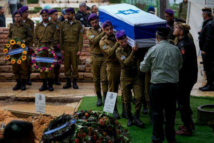 Israeli soldiers carry the flag-draped casket of Staff Sgt. Birhanu Kassie during his funeral a ...