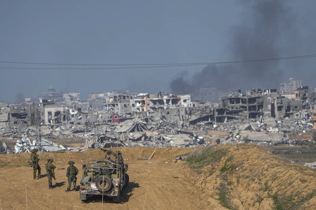 Israeli army troops are seen near the Gaza Strip border, in southern Israel, Sunday, Dec. 24, 2 ...