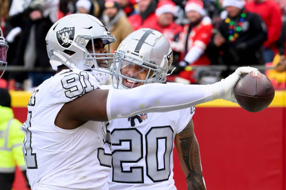 Las Vegas Raiders defensive tackle Bilal Nichols (91) celebrates with Raiders safety Isaiah Pol ...