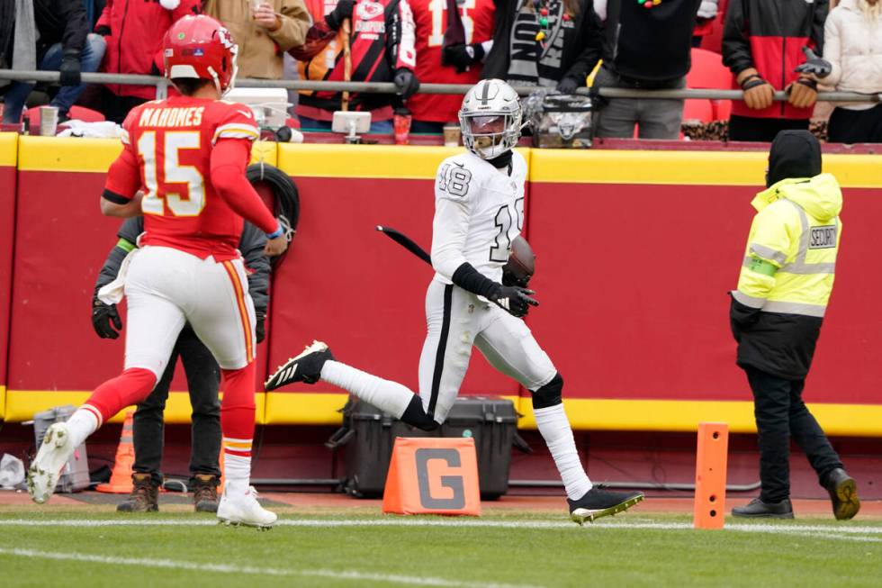 Las Vegas Raiders cornerback Jack Jones scores after intercepting a pass and running it back fo ...