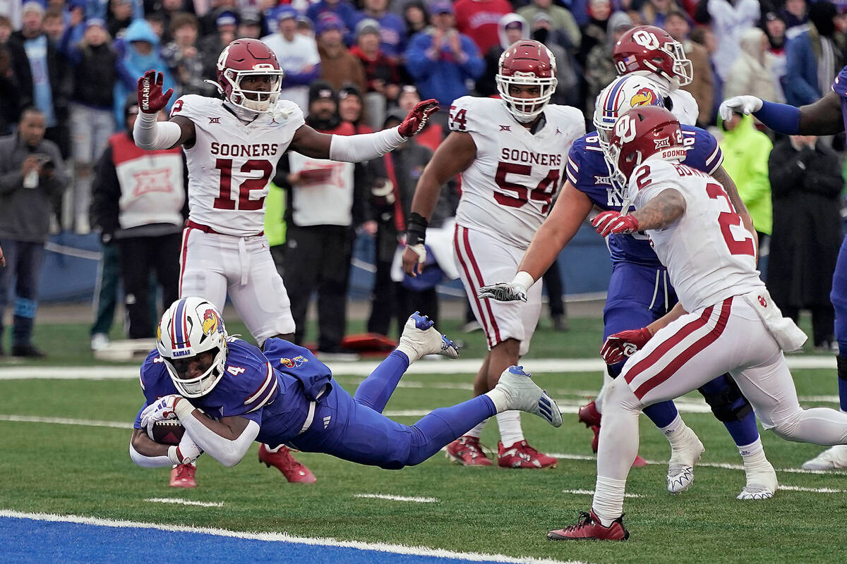 Kansas running back Devin Neal dives into the end zone to score a touchdown during the second h ...