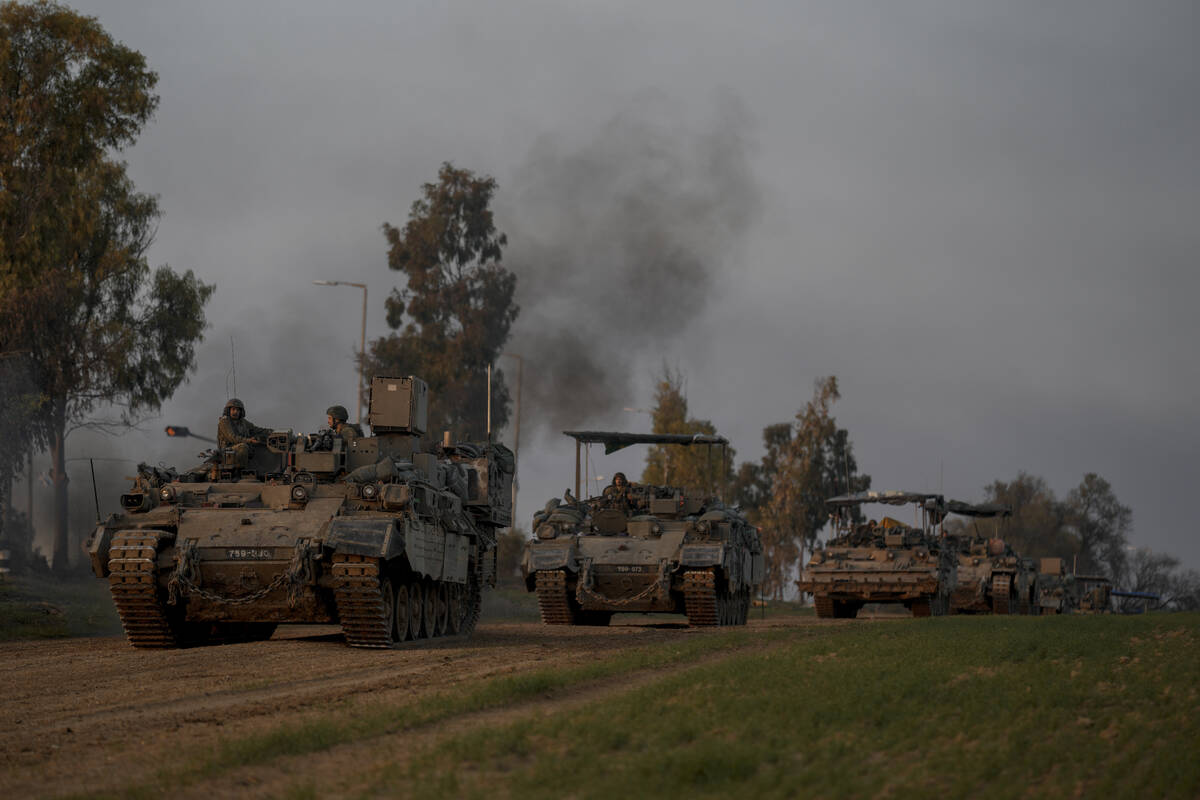 A convoy of Israeli army armoured personnel carriers (APC) moves near the Israeli-Gaza border, ...