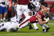 San Francisco 49ers running back Christian McCaffrey, right, scores past Baltimore Ravens safet ...