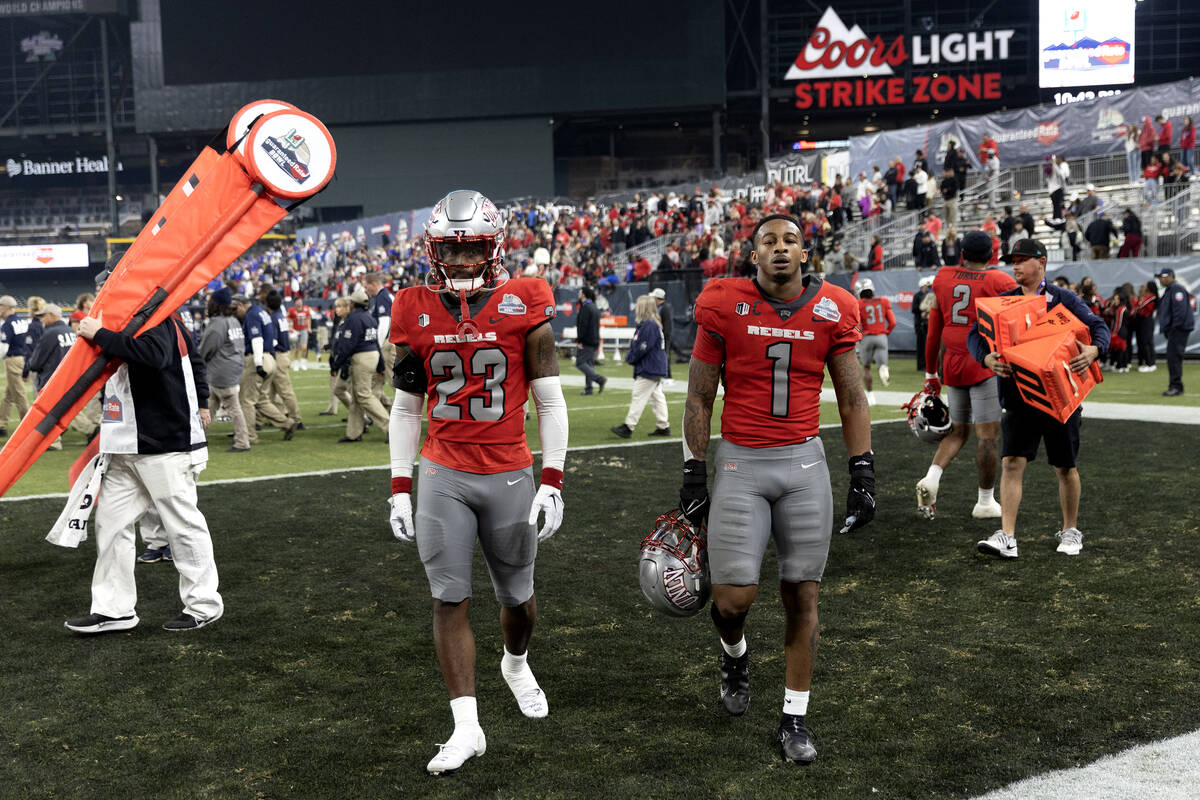 UNLV Rebels defensive back Quentin Moten (23) and Jerrae Williams (1) walk off the field after ...