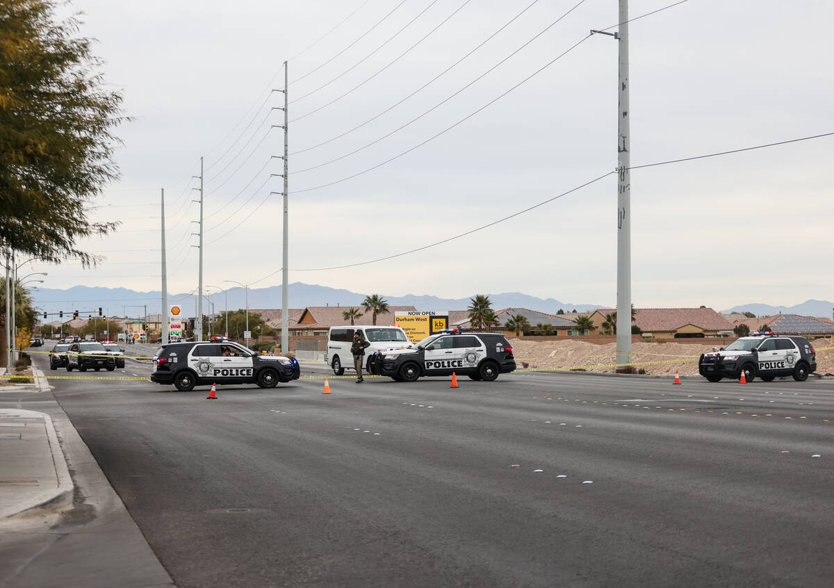 Police investigate the scene of an officer involved shooting in the area of Blue Diamond Road a ...