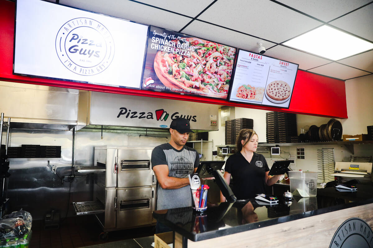 Co-owners and husband and wife duo Gabriel Jordan, left, and Kellie Jordan, right, work at Pizz ...