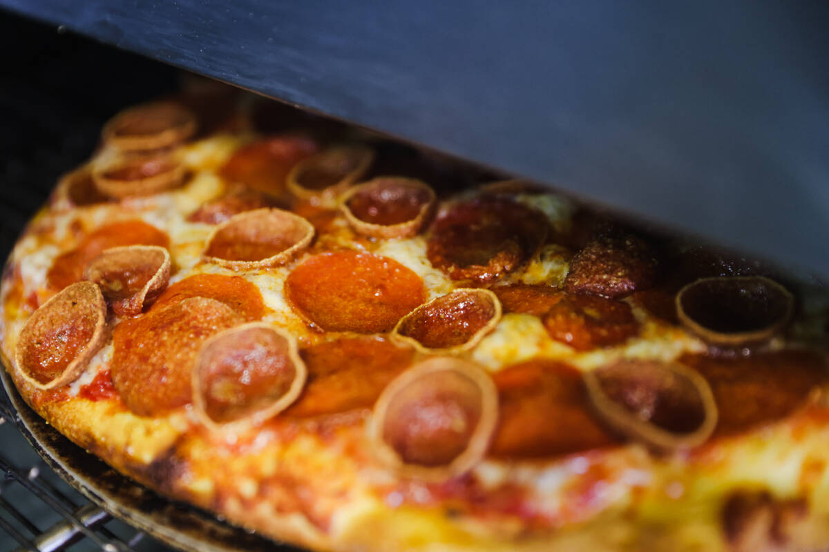 Pizza coming out of the oven at Pizza Guys, a California-based pizza restaurant chain, in Las V ...