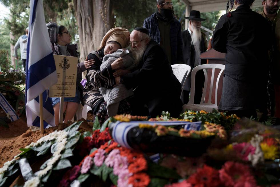 The wife, center, of the Israeli staff sergeant Elisha Yehonatan Lober, who was killed in battl ...